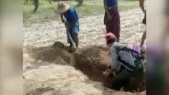 Men digging up graves in Myanmar