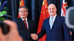 中國總理李強於新西蘭總理盧克森握手