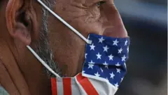 Man wearing US flag mask