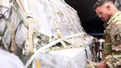 An airman carrying baby formula