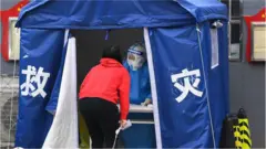 A Beijing resident gets a Covid-19 swab test.