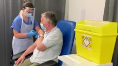 Prof Alex Brown gets a third dose of vaccine