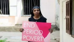 women holding a sign saying end of poverty