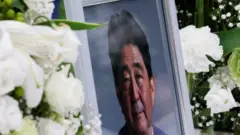 A picture of late former Japanese Prime Minister Shinzo Abe, who was shot while campaigning for a parliamentary election, is seen at Headquarters of the Japanese Liberal Democratic Party in Tokyo, Japan July 12, 2022.
