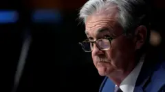 Chairman of the Federal Reserve Jerome Powell listens during a Senate Banking Committee hearing on "The Quarterly CARES Act Report to Congress" on Capitol Hill in Washington, U.S., December 1, 2020.