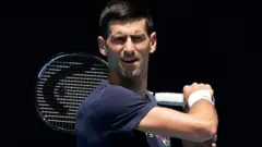 Novak Djokovic of Serbia plays a forehand shot during a practice session ahead of the 2022 Australian Open at Melbourne Park on January 12, 2022 in Melbourne, Australia.