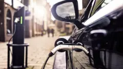 An electric car charging on the road