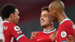 Diogo Jota celebrates with team-mates Trent Alexander-Arnold and Fabinho