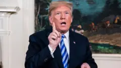 . Trump signs a National Security Presidential Memorandum as he announces the withdrawal of the United States from the Iran nuclear deal