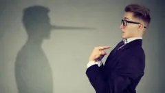 Man pointing at himself while lying