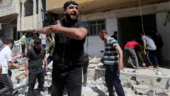 Palestinian man react for di scene wia Israeli strike hit one house for southern Gaza Strip May 12, 2021