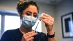 A French doctor prepares the AstraZeneca jab 25 February, 2021
