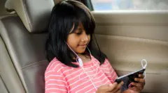 A girl stares down at a phone screen