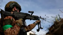 A Ukrainian soldier seen firing a gun
