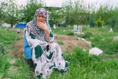 Nehal Toqat sits in a graveyard