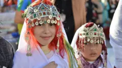 Amazigh girls wear traditional clothes on the eve of the 2970th Amazigh New Year near the parliament in the capital of Rabat, Morocco, 12 January 2019