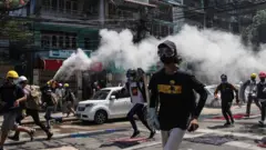 Protesters run from police in Mynamar