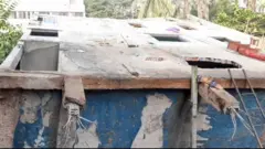 বাবুরাইল এলাকায় ধসে পাশের একটি খালে গিয়ে পড়ে এই ভবনটি