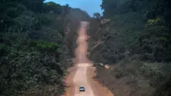 Cars on a clay road in the Amazon