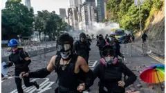 Protesters run on a street during an attempt to leave Polytechnic University