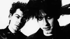 Lol Tolhurst and Robert Smith of The Cure, posed, studio portrait, 1983.