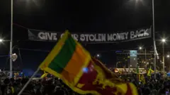 Demonstrators take part in a night protest at protest camp on April 30, 2022 in Colombo, Sri Lanka. Angry youths have been camping in the streets near President Gotabhaya Rajapaksa's office since April 9. The camp, called the "Gota Go Gama", or Gota go village in the Sinhalese language, has been set up to demand the resignation of President and his government.