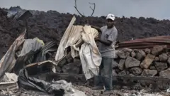 Man sorting through rubble