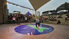 A b-boy performs during the BREAKIDS