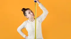 Una mujer mide su estatura