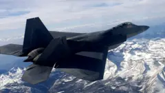 F-22 jet flying over the Sierra Nevada mountains in an archive photo