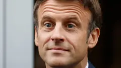 Emmanuel Macron arriving to vote in the second stage of French parliamentary elections at a polling station in Le Touquet, northern France