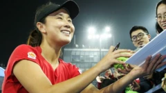 Chinese tennis player Peng Shuai signing autographs