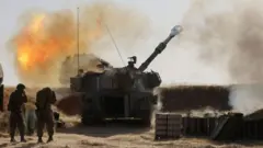 Israeli soldiers fire a 155mm self-propelled howitzer towards targets in the Gaza Strip from their position near the southern Israeli city of Sderot on May 12, 2021.