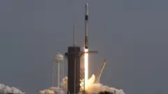 A SpaceX Falcon 9 rocket, carrying the Crew Dragon astronaut capsule, lifts off on an in-flight abort test from the Kennedy Space Center in Cape Canaveral
