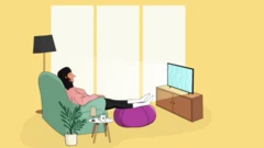 A woman sits on her armchair watching TV