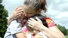 Olga reunited with two of her adopted children