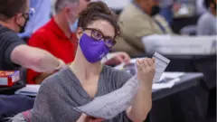 Poll worker counts ballots in Georgia (4 November)