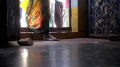 గుడిలోకి అడుగుపెడుతున్న మహిళ
