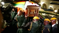 The body of former Zimbabwean President Robert Mugabe arrives at the Blue Roof, his residence in Borrowdale, Harare, Zimbabwe, on 11 September 2019