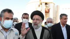 Iranian President Ebrahim Raisi (C) gestures while visiting the Bushehr nuclear plant in Iran (8 October 2021)