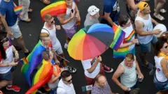 People march with their rainbow colors from the parliament building in Budapest downtown during the lesbian, gay, bisexual and transgender (LGBT) Pride Parade in the Hungarian capital