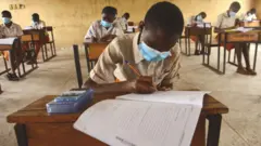 Students dey write exam for classroom