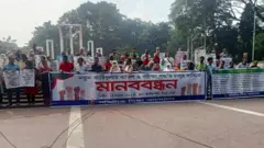 নতুন পাঠ্যক্রমের সমালোচনা করে সম্প্রতি ঢাকা কেন্দ্রীয় শহীদ মিনারের সামনে মানববন্ধন করেন অভিভাবকরা।