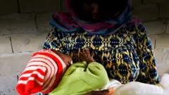 Woman wey dey hold piin