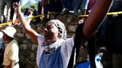 A woman reacts after a fire destroyed part of an orphanage, in Port-au-Prince, Haiti, 14 February, 2020.