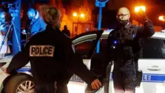 Police officers secure the area near the scene of a stabbing attack in the Paris suburb of Conflans-Sainte-Honorine, France. Photo: 16 October 2020.