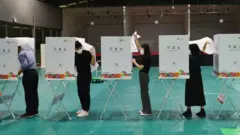 투표소에서 관계자들이 기표소 등을 최종 점검하고 있다