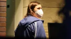 Krystina Timanovskaya walks with her luggage inside the Polish embassy in Tokyo