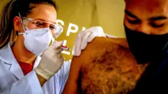 a man taking a vaccine