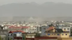 Smoke rises after two explosions reported outside Hamid Karzai International Airport.